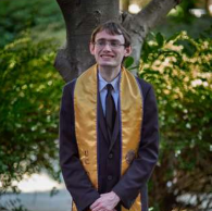 Daniel poses with a stole in front of the camera.