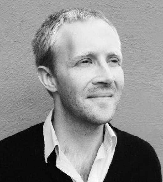 A black and white photo of Ian Campbell looking beyond the camera.