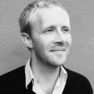 A black and white photo of Ian Campbell looking beyond the camera.