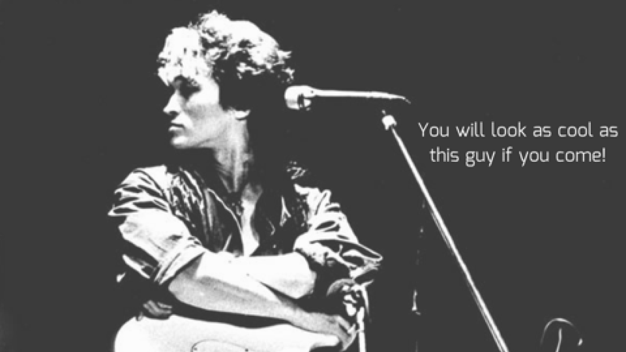 a black and white photo of a rock and roll musician and their guitar