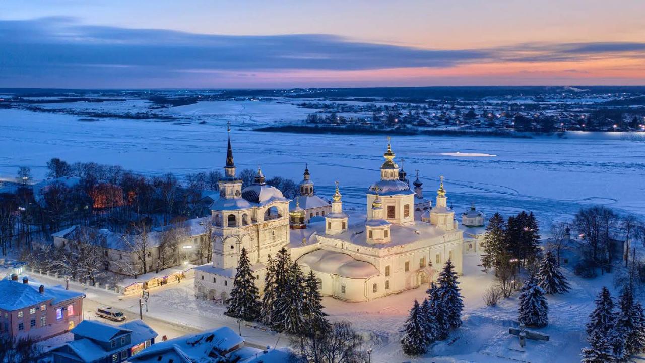A white elaborate church by a river of ice.