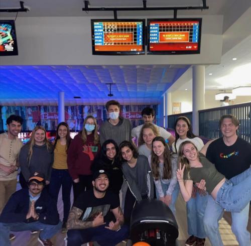A group shot of students posing for a photo in a bowling alley