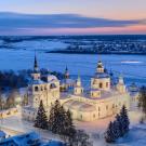 A white elaborate church by a river of ice.
