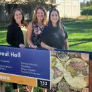Your advising team standing behind a sign for sproul hall